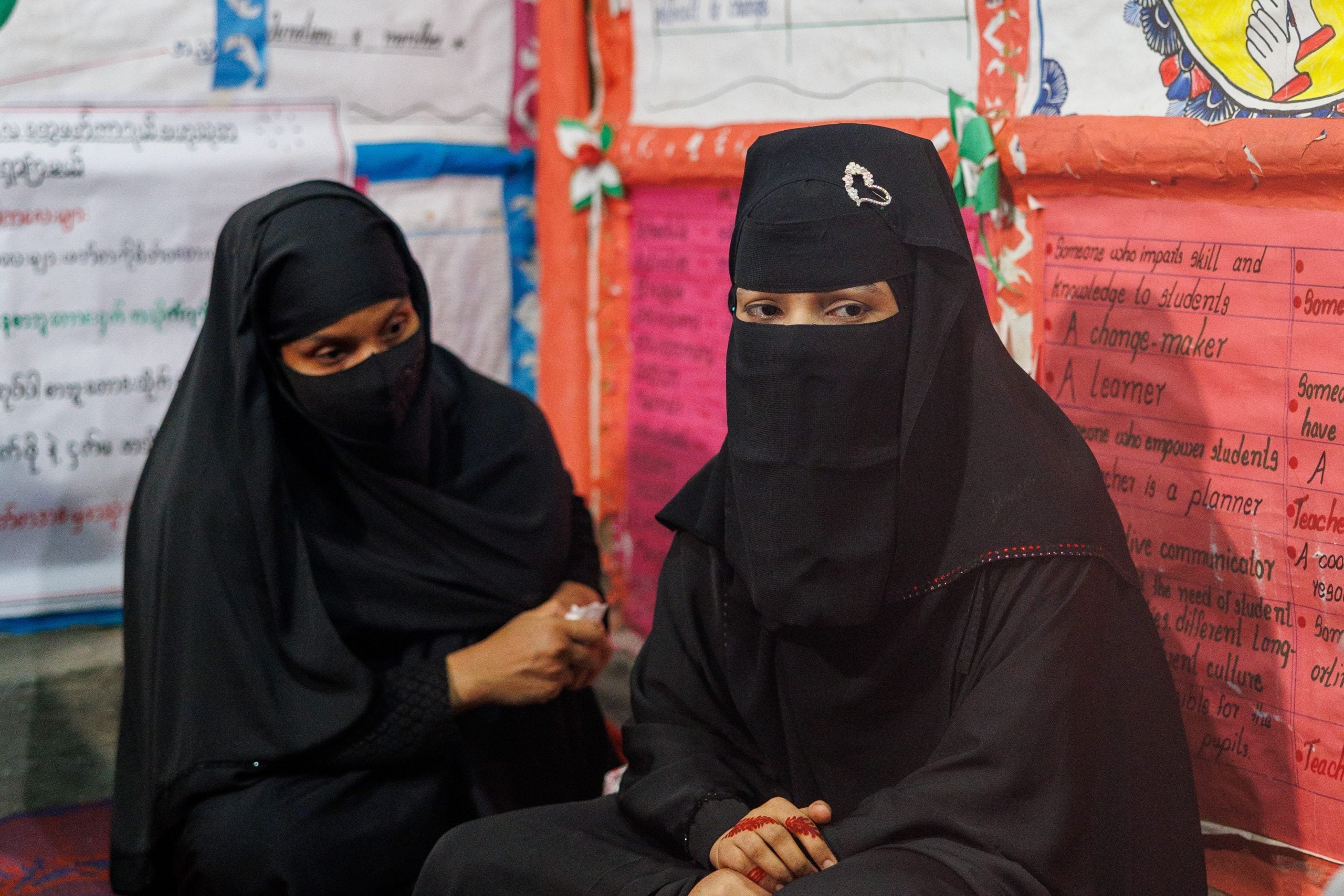 Refugee girl Kamila (left) and her sister (right) sharing their story of trauma and survival
